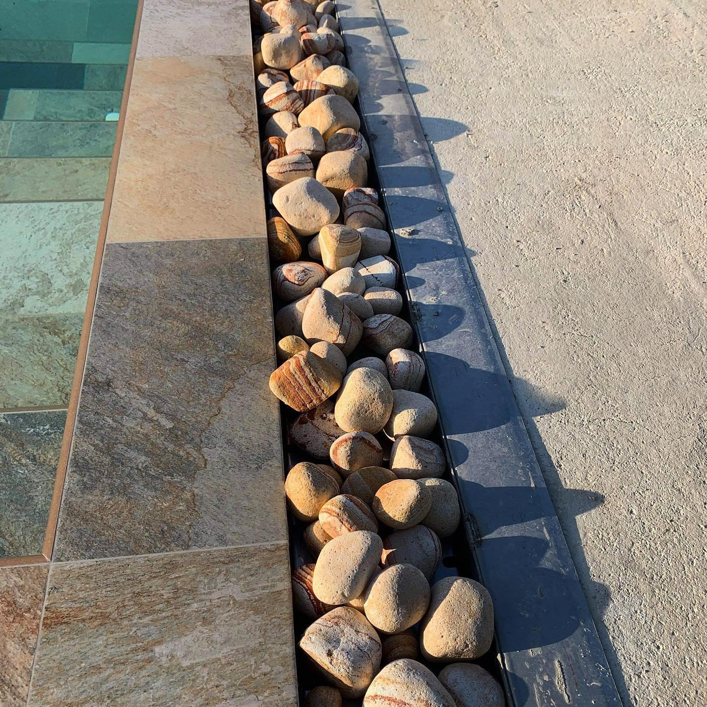 Réalisation d'un abord de piscine en galets Arc-en-ciel